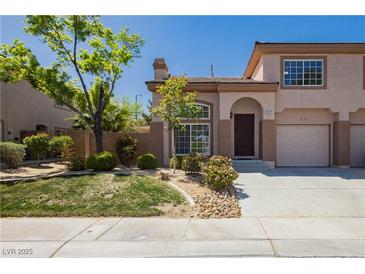 Charming townhome featuring desert landscaping, a private garage, and a welcoming entrance at 1617 Cave Spring Dr, Henderson, NV 89014
