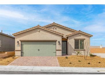 Charming single-story home featuring a two-car garage and low-maintenance desert landscaping in front at 2739 Avril Point St, Las Vegas, NV 89156