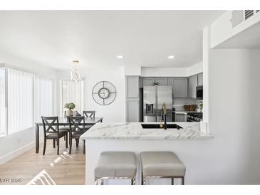 Bright kitchen and dining area with stainless steel appliances and marble countertops at 3425 E Russell Rd # 202, Las Vegas, NV 89120