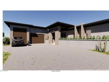 Contemporary home featuring a desert landscape, modern architecture, and a large paved driveway at 5885 St Ebbes Ct, Las Vegas, NV 89131