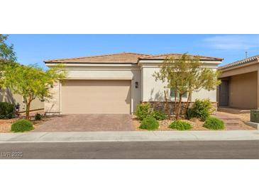 Charming single-story home featuring a two-car garage and desert landscaping for low maintenance appeal at 8668 Marcana St, Las Vegas, NV 89166
