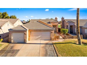 Charming single-story home featuring a three-car garage and well-maintained landscaping at 1199 Golf Club, Laughlin, NV 89029