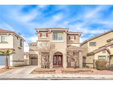 Charming two-story home with red shutters and an arched entrance, set under a bright blue, partly cloudy sky at 1324 Spice Ridge Ct, Henderson, NV 89012
