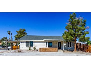 Charming single-story home with a spacious front yard and a covered carport at 208 W Alma St, Overton, NV 89040