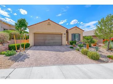 Charming single-story home featuring a well-manicured front yard and a two-car garage at 2601 Bechamel Pl, Henderson, NV 89044