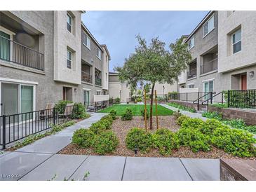 Beautifully landscaped community courtyard with walkways and manicured green spaces at 2845 Copper Wind Ln # 4, Las Vegas, NV 89183