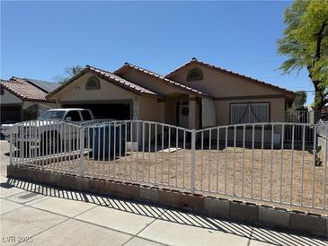 Charming single-story home featuring a front yard with metal fencing at 4923 Arizona Ave, Las Vegas, NV 89104