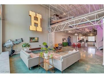 Spacious living room with high ceilings, modern decor, and open floor plan; perfect for entertaining at 5096 Thunder River Cir, Las Vegas, NV 89148
