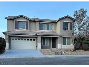 Charming two-story home featuring a two-car garage and well-maintained front yard at 1004 Windy Ferrell Ave, North Las Vegas, NV 89081