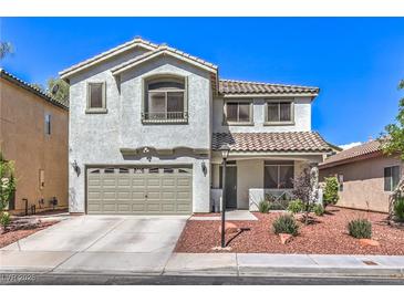 Charming two-story home with a well-maintained front yard and a two car garage at 11143 Castellane Dr, Las Vegas, NV 89141