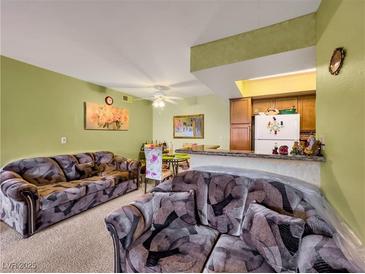 Cozy living room featuring plush sofas, a dining area, and a kitchen with modern appliances at 1455 E Katie Ave # K14, Las Vegas, NV 89119