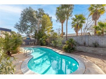 A refreshing pool with lush landscaping provides a private backyard oasis at 6223 Foothill Blvd, Las Vegas, NV 89118
