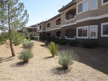 A multi-story apartment building has well-kept landscaping and an inviting facade at 833 Aspen Peak Loop # 1524, Henderson, NV 89011
