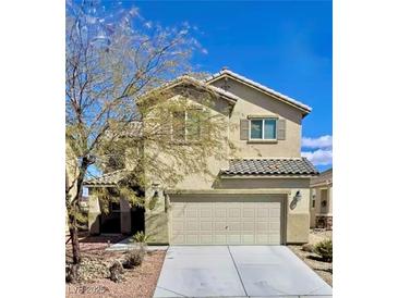 Charming two-story home featuring desert landscaping, a two-car garage, and neutral stucco facade at 948 Crescent Falls St, Henderson, NV 89011