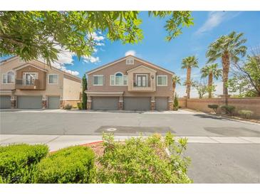 Inviting two-story home with a three car garage, balcony, and desert landscaping at 9490 Thunder Sky St # 102, Las Vegas, NV 89178