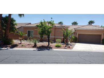Charming single story home with a tile roof, low maintenance landscaping, and an attached two car garage at 10015 Wonderful Day Dr, Las Vegas, NV 89148