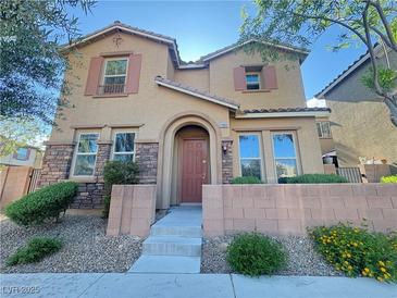Charming two-story home featuring a well-maintained front yard with stone accents, and an inviting entrance at 11083 Ketchikan St, Las Vegas, NV 89179