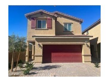 Two-story home showcasing a two-car garage, well-kept landscaping and desert plants at 1433 Gable Falls Pl # 95, North Las Vegas, NV 89084