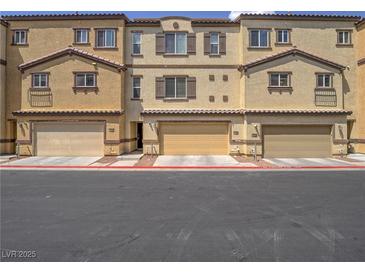 Charming townhouse with tan exterior, brown trim, and attached garages, ideal for modern living at 1525 Spiced Wine Ave # 19103, Henderson, NV 89074