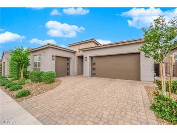 Charming home featuring a spacious three-car garage and neatly landscaped front yard at 2654 Summit Springs St, Henderson, NV 89044