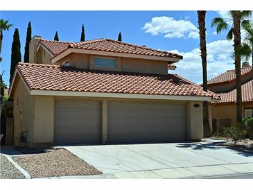 Two story home featuring a terracotta-tiled roof and a two-car garage at 4732 Illustrious St, Las Vegas, NV 89147