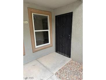 Home entrance featuring a black security door and neutral toned walls at 555 E Silverado Ranch Blvd # 1034, Las Vegas, NV 89183