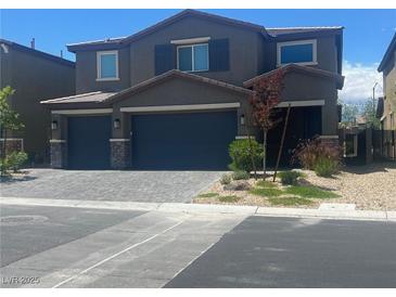 Charming two-story home with a two-car garage and a beautifully landscaped front yard at 7527 Ardenno St, North Las Vegas, NV 89084
