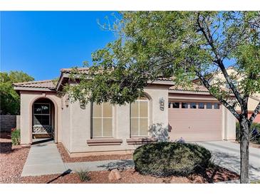 Charming single-story home featuring a desert landscape and a two-car garage at 10410 Nostalgia Cir, Las Vegas, NV 89135