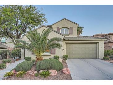 Charming two-story home with landscaped yard, desert landscaping, and attached two car garage at 11345 Espadrille Ct, Las Vegas, NV 89138