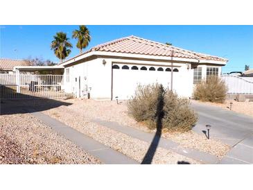 Charming single-story home with a well-maintained front yard and attached two-car garage at 1214 Emerald Stone Ave, North Las Vegas, NV 89081
