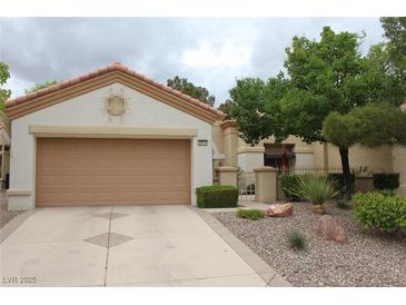 Charming single-story home with a two-car garage and well-maintained landscaping at 2013 Capestone St, Las Vegas, NV 89134