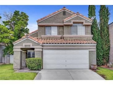 Charming two-story home featuring a terracotta roof, attached two-car garage, and low maintenance landscaping at 2429 Sun Shores Dr, Las Vegas, NV 89128