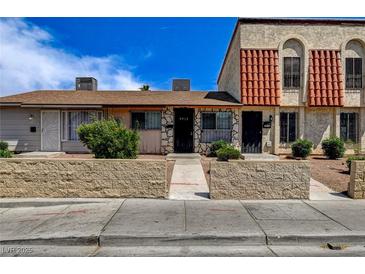 Charming townhome featuring unique stonework, a red tile roof, and well-maintained landscaping at 3912 Palos Verdes St, Las Vegas, NV 89119