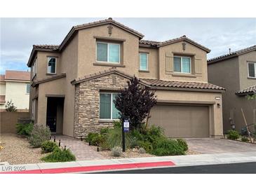 Inviting two-story home with stone accents, a two-car garage, and a well-maintained front yard at 528 Sunny Pointe St, Henderson, NV 89011