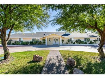 Charming single-story home with lush front yard landscaping and circular driveway at 6419 Eldora Ave, Las Vegas, NV 89146