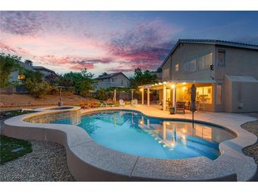 Inviting backyard pool and spa with covered patio, perfect for outdoor entertaining and relaxation at 8253 Ruby Mountain Way, Las Vegas, NV 89128