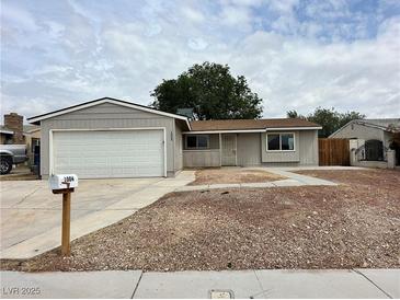 Charming single-story home with an attached garage and low-maintenance landscaping at 1004 Stone River Dr, North Las Vegas, NV 89030