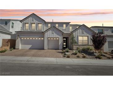 Beautiful two-story home featuring a brick driveway, three-car garage, modern design and well-manicured landscaping at 10196 Sequoia Glen Ave, Las Vegas, NV 89166