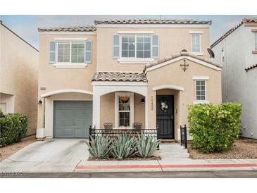 Charming two-story home with desert landscaping, covered entry and front porch, and an attached garage at 10400 Beautiful Fruit St, Las Vegas, NV 89183