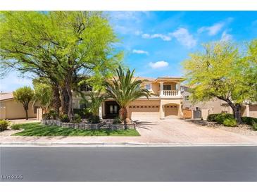 Stunning two-story home boasting desert landscaping, mature trees, and a three-car garage at 11237 Campsie Fells Ct, Las Vegas, NV 89141