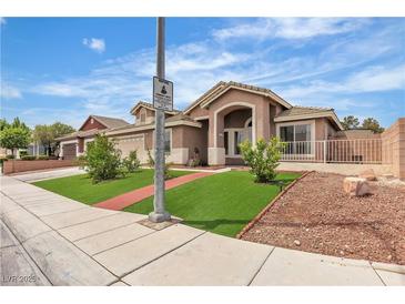 Charming single-story home featuring an arched entryway and manicured front lawn at 4537 Colonial Canyon St, North Las Vegas, NV 89031