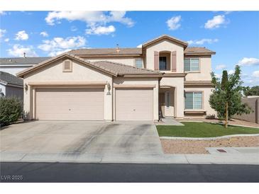 Charming two-story home boasts a three-car garage, manicured lawn, and inviting curb appeal at 5769 Larkdale St, Las Vegas, NV 89120