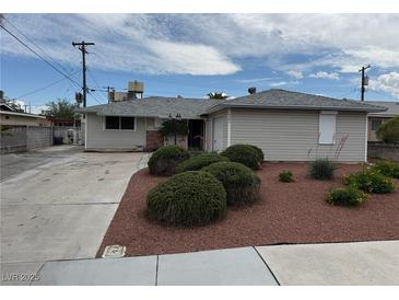 Charming single-story home featuring a well-maintained lawn and an expansive concrete driveway at 6205 Parsifal Pl, Las Vegas, NV 89107