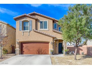 Charming two-story home featuring a brown garage door, desert landscaping, and blue shutters at 6276 Point Isabel Way, Las Vegas, NV 89122