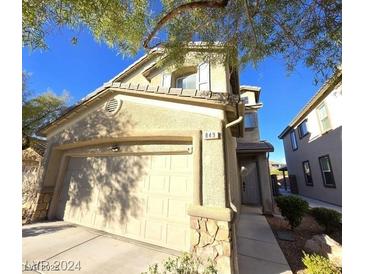 Charming two-story home featuring an attached two-car garage with stone accents, and well-maintained landscaping at 849 Purdy Lodge St, Las Vegas, NV 89138