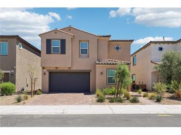 Charming two-story home with desert landscaping, a brick driveway, and attached two-car garage at 8724 Scalpay St, Las Vegas, NV 89166