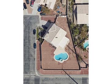 Aerial view of property showcasing a refreshing pool, set on a spacious lot in a desirable neighborhood at 10290 Marion Morrison Ct, Las Vegas, NV 89183
