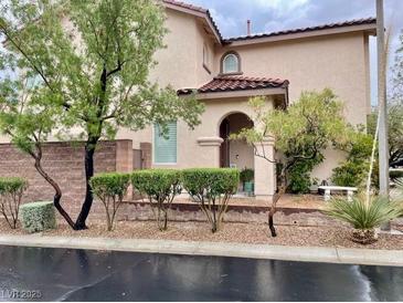 Charming two-story home with desert landscaping and a cozy front porch, perfect for enjoying the outdoors at 10294 Running Falls St, Las Vegas, NV 89178