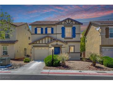 Charming two-story home with blue shutters, a well-manicured lawn, and a two-car garage at 11919 Jersey Lilly St, Las Vegas, NV 89183
