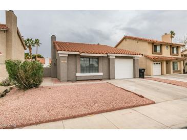 Charming single-story home with a red tile roof and low-maintenance landscaping at 1744 La Cruz Dr, Henderson, NV 89014